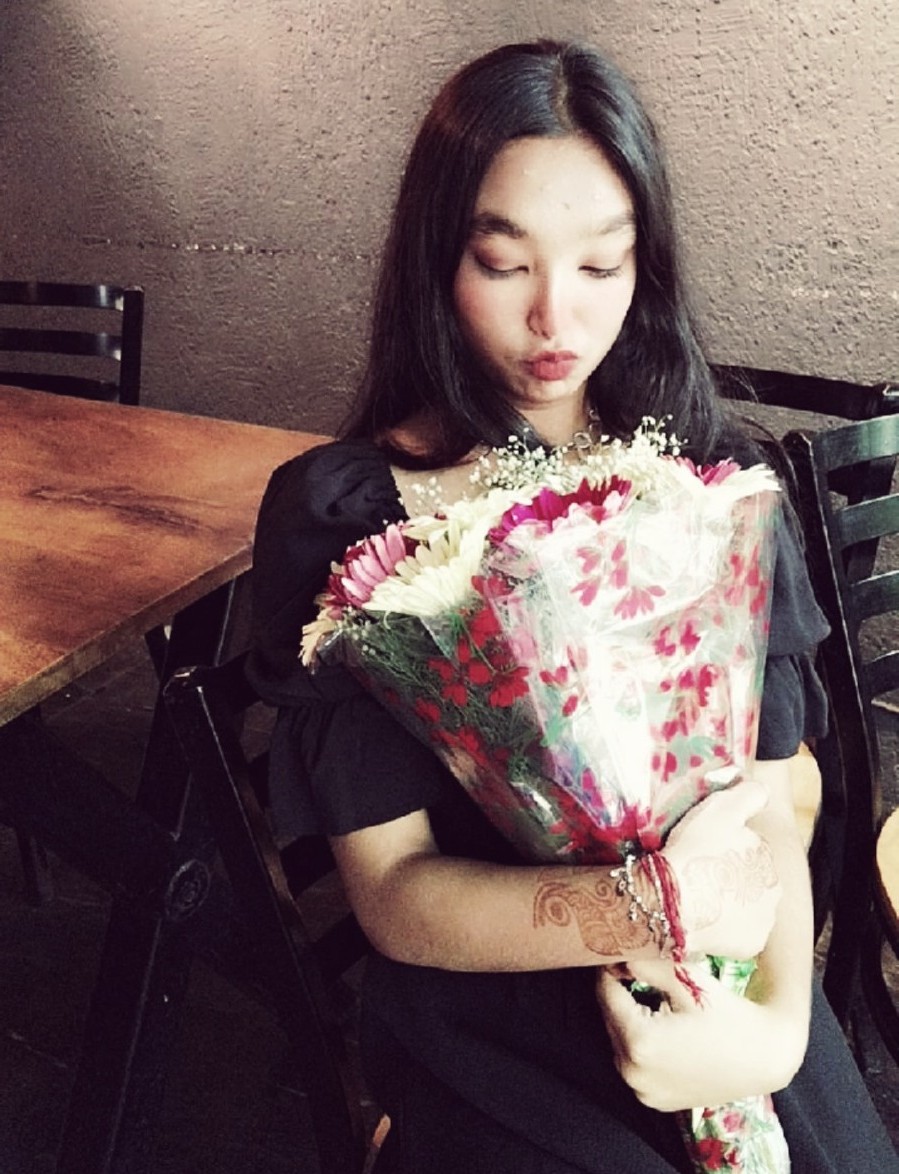 Tanya holding a bouquet of flowers