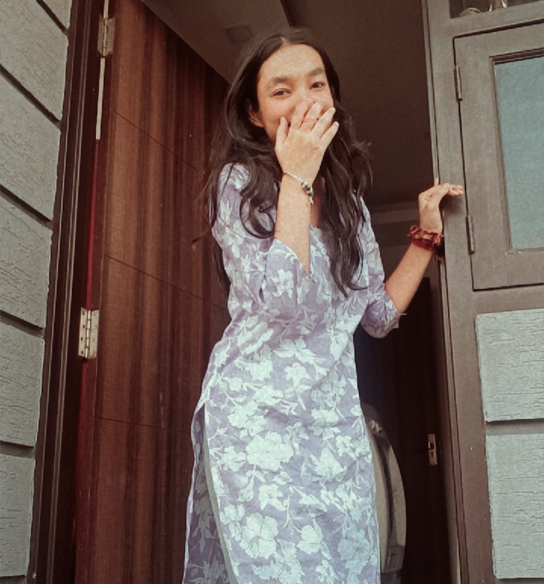 Tanya in a lavender floral kurta at a doorway