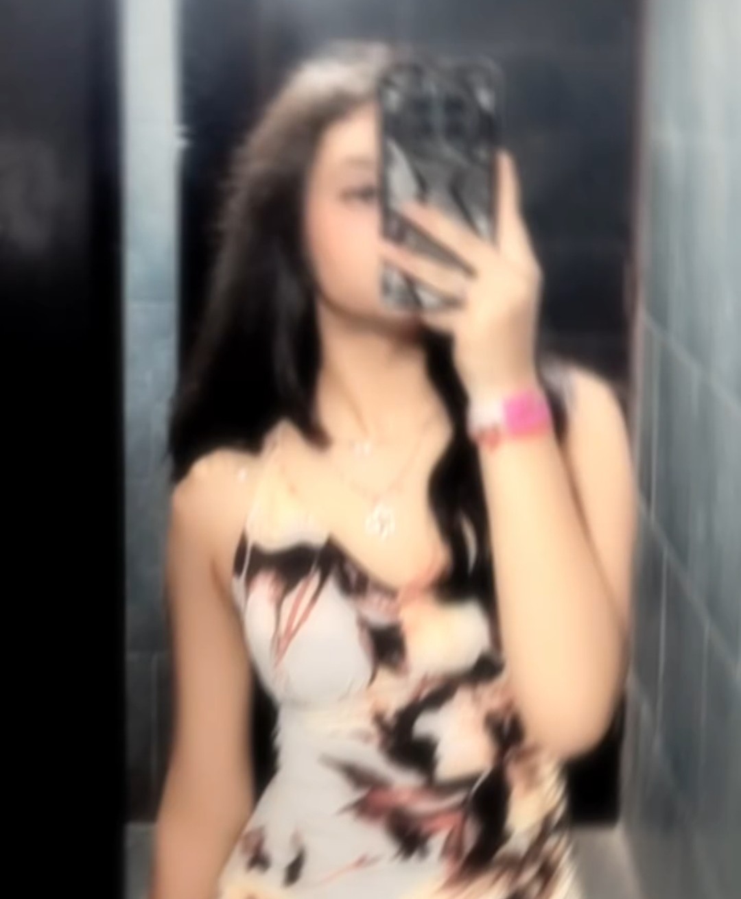 Tanya taking a mirror selfie in a printed corset top